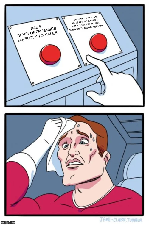 Two Buttons meme: sweating person choosing between "Pass developer names directly to sales" and "Proactively flag enterprise signals with context so the community stays healthy"